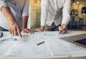 Two people going over projections for the network cabling industry